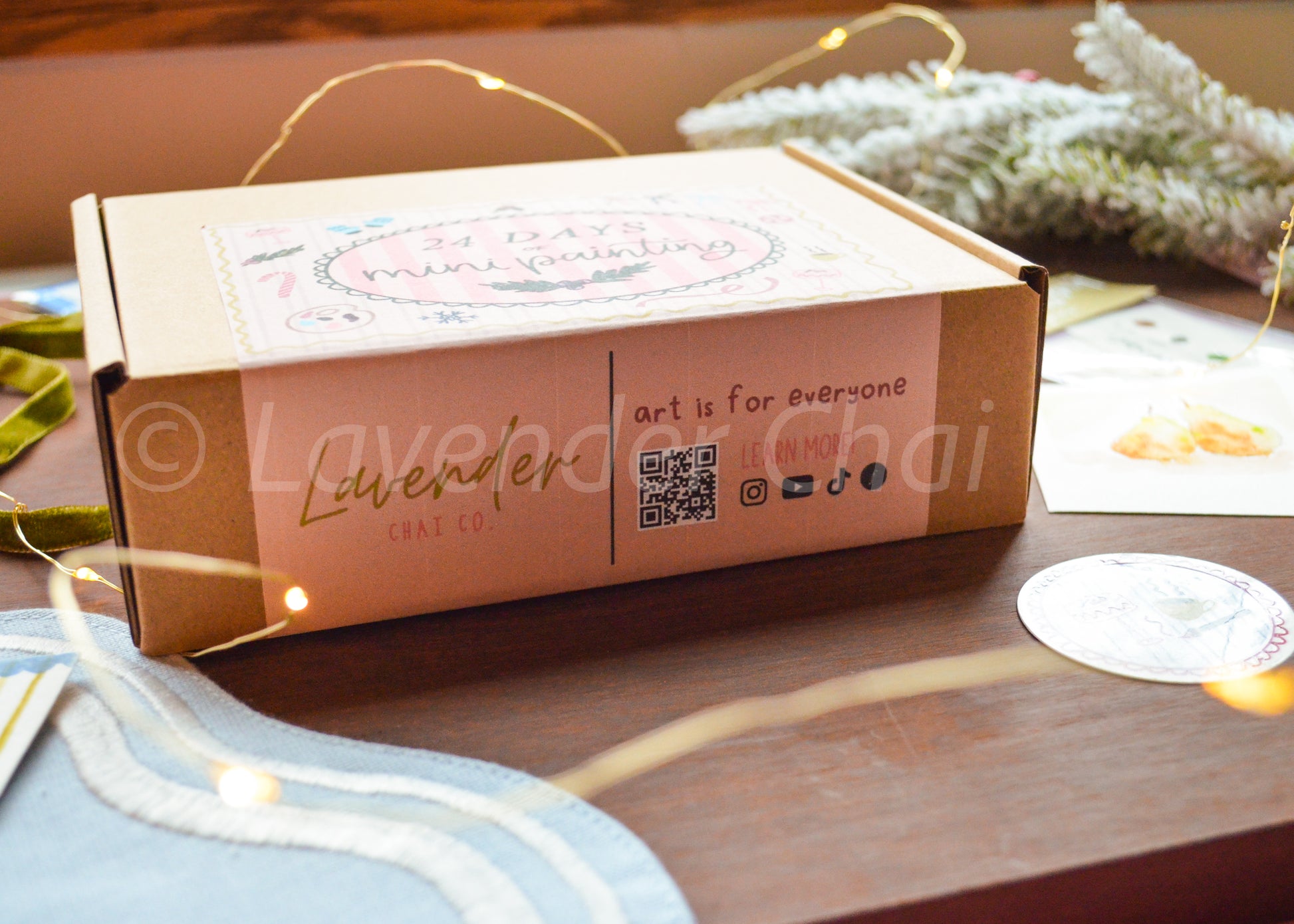 Lavender Chai Co product packaging on a wooden surface with decorative elements.